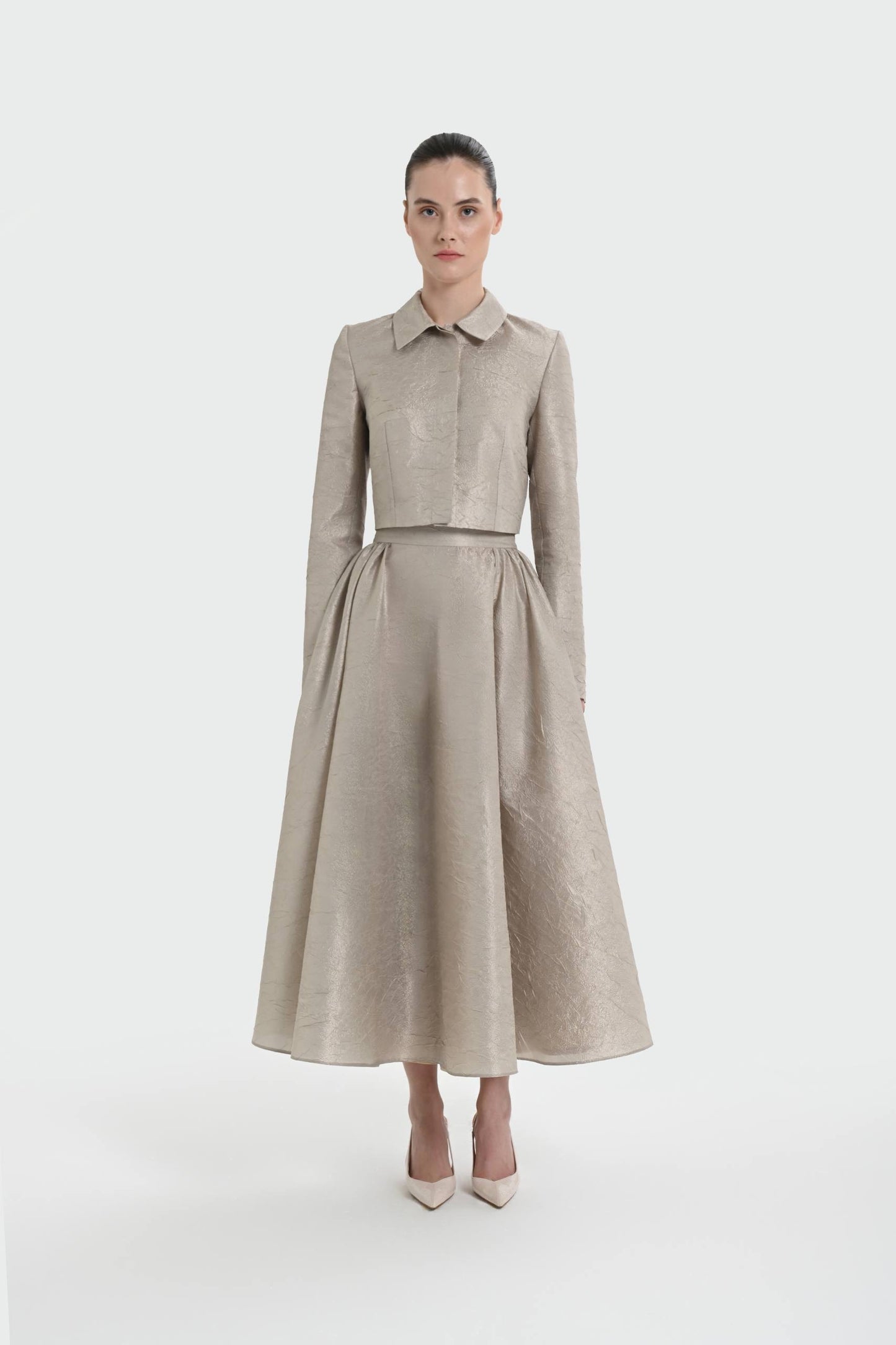 Elegant champagne two-piece set featuring a structured top and a flowing A-line skirt. 9175